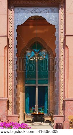 Abu Dhabi, Uae , March 2021.table And Chairs In Open Terrace Cafe Under Traditional Ornate Glass Arc