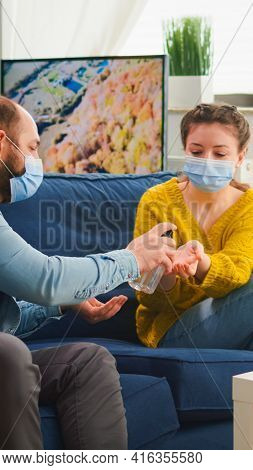 Multi Ethnic Friends Using Hand Gel To Prevent Coronavirus Infection
