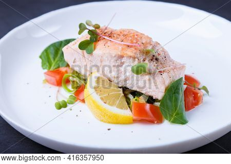 Trout (salmon) With Vegetables, Lemon And Microgreens, Cooked By The Confit Method. Traditional Fren