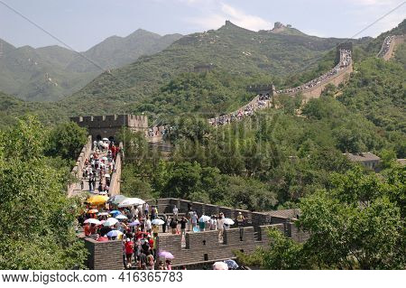 BADALING, CHINA - JULY 2006: Tourists line the Great Wall at Badaling, China. About 10 million people trek to the historic Great Wall every year making it China's most popular tourist destination.