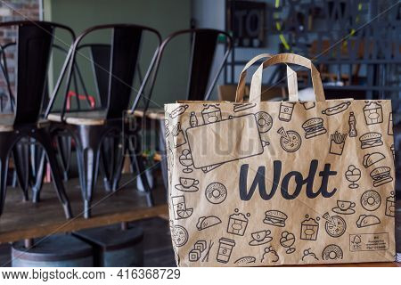 Thessaloniki, Greece - April 02 2021: Wolt Food Delivery Bag With Company Logo, On Restaurant. Finis