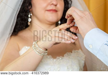 The Groom Putting The Bride On The Index Finger At A Jewish Wedding Close-up.