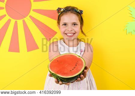 A Little Girl Of European Appearance With A Juicy Watermelon. Child On A Bright Summer Background. N