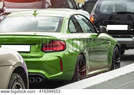 Green Sports Car On The Street Of The City Details Stop Lights