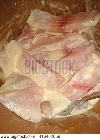 The Process Of Cooking Fish In Batter Close-up. High Quality Photo
