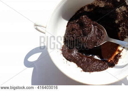 Spent Coffee In The Cup On White Background. Recycling Used Coffee Grounds In The Garden As Organic 