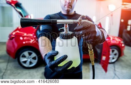 A Car Service Worker Cleans Interiror With A Special Foam Generator