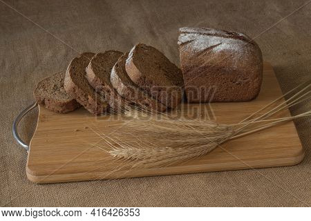 Rye Bread With Koes On A Wooden Table.