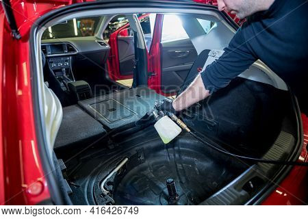 A Car Service Worker Cleans Interiror With A Special Foam Generator