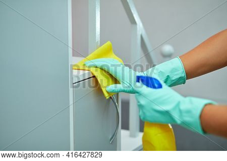 Bearded Man Cleaning Home Table Surface With Towel And Gloves, Disinfectant Spray Bottle