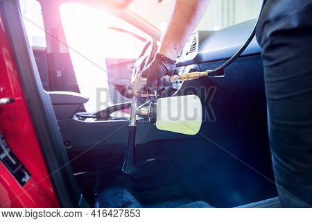 A Car Service Worker Cleans Interiror With A Special Foam Generator