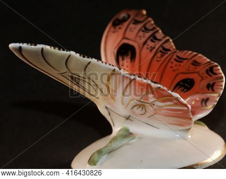 Porcelain Butterfly Figurine Isolated On Black Background