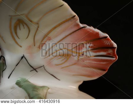 Porcelain Butterfly Figurine Isolated On Black Background