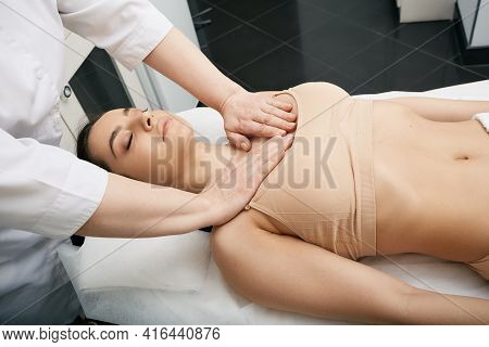 Masseur Doing Decollete Massage To Woman Patient For Skin Firmer And More Resilient At A Spa Salon