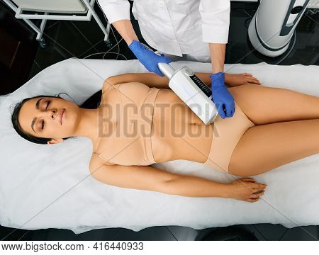 Endospheres Anti-cellulite Therapy. Brunette Woman Enjoys Belly Massage With Endosphere Machine For 
