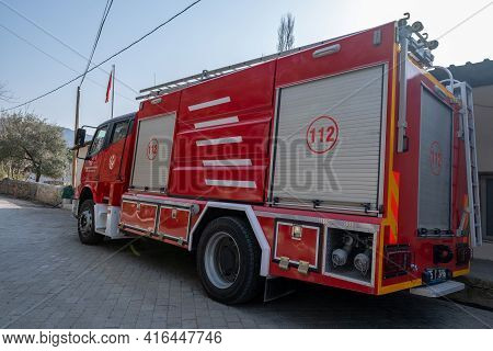 Seferihisar, Izmir, Turkey - 03.09.2021: Side View Of Red Traditional Fire Engine Parked In Front Of