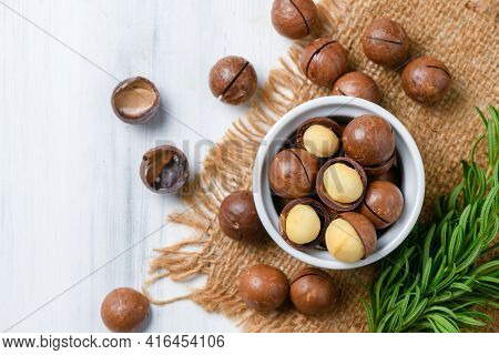 Top View Of Dry Roasted Macadamia Nut In White Cup On Wood Background,macadamia Nuts Are Loaded With