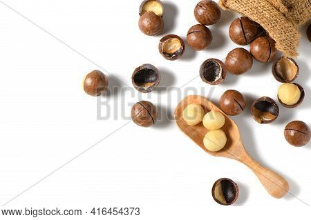 Peeled Macadamia Nuts In Wood Spoonl Isolated On White Background, Macadamia Nuts Are Loaded With Fl
