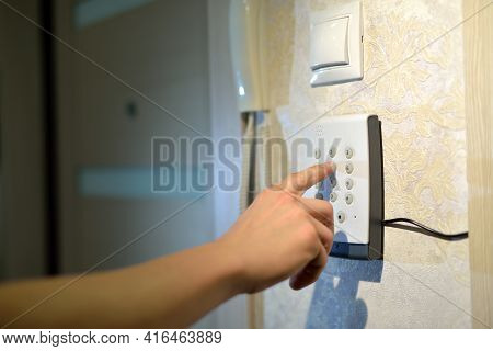 Mans Hand Dials The Code From The Security System At Home On A Keypad With Numbers From Theft And Bu