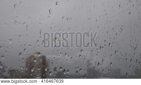 Fall Rainy Weather Background. Raindrops On Window Glass Surface Closeup. Water Drops Outside And Bl