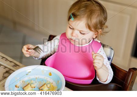 Adorable Baby Girl Eating From Spoon Mashed Vegetables And Puree. Food, Child, Feeding And People Co