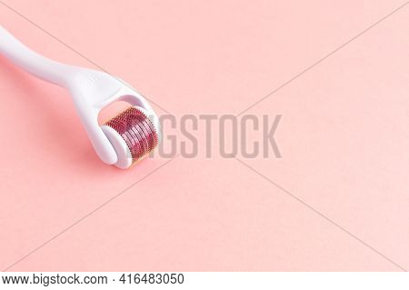 Dermaroller, Mesoroller, Microneedling. Cosmetic Instrument With Micro Needles On Pink Background Fo