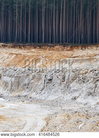 Large Glass Sand Quary With The Edge Of The Forest  Waiting To Break The Limits And Continue Mining.