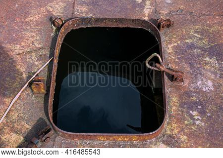 Old Rusty Sunken Pier In The Water On The Territory Of The River Port. Old Sunken Rusty Structure On