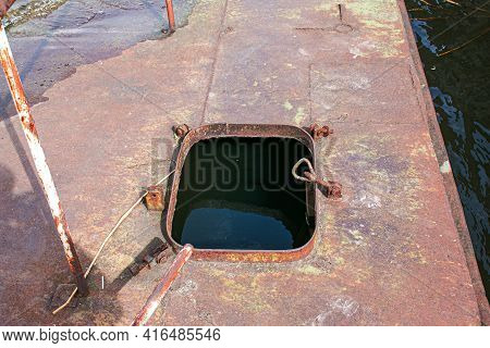 Old Rusty Sunken Pier In The Water On The Territory Of The River Port. Old Sunken Rusty Structure On