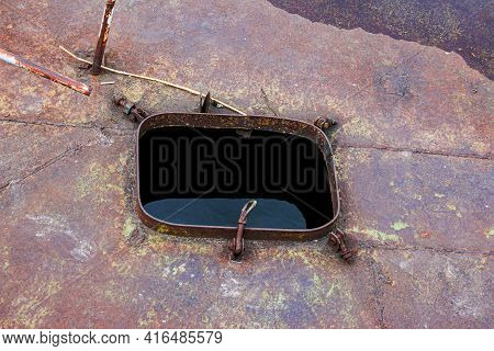Old Rusty Sunken Pier In The Water On The Territory Of The River Port. Old Sunken Rusty Structure On