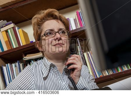 Image Of A Busy Woman Telecommuting At Her Desk At The Home. Working At Home Became An Important Rec