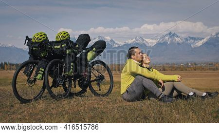The Man And Woman Travel On Mixed Terrain Cycle Touring With Bikepacking. The Two People Journey Wit