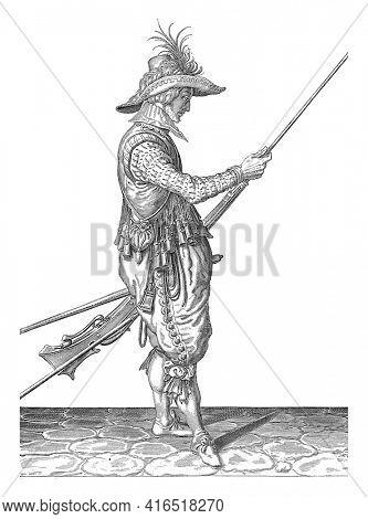 Soldier pushing powder and bullet with his ramrod into the barrel of his musket, vintage engraving.