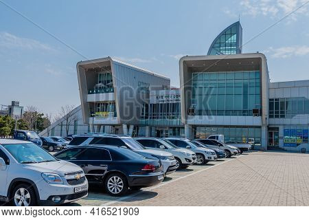 Pyeongtaek, South Korea; April 6, 2021: Rows Of Cars Parked In Front Of Jeongok Marina Clubhouse On 