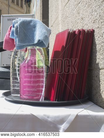 Waiter Tray Full Of Disinfectant Spray Products Over Restaurant Terrace. Covid-19 Measurements In Ho