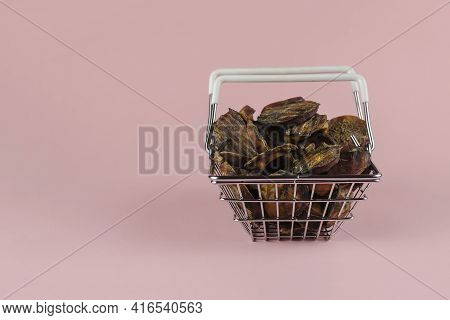 Shopping Basket With Dog Treats On A Pink Background. Natural Treats In A Metal Basket. Dried Bovine