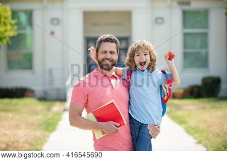 Portrait Of Teacher And Happy Pupil. Father Supports And Motivates Son. Kid Going To Primary School.