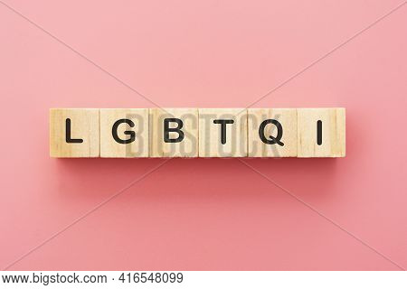 Lgbtqi Letters On Wooden Cubes Over Pink Background. Abstract Concept Of Human Rights, Diversity, Eq