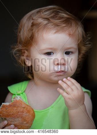 Cute Toddler Child Eating Sandwich, Self Feeding Concept
