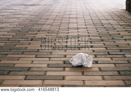 End Of Quarantine. Used Medical Mask Lies On The Ground