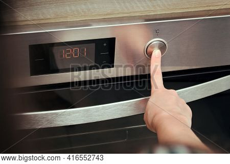 Oven Switch In The Kitchen, Hand Presses Button
