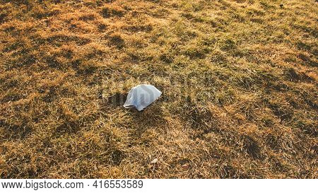 The Medical Mask Is Thrown On The Grass. End Of Restrictions, The Virus Recedes.