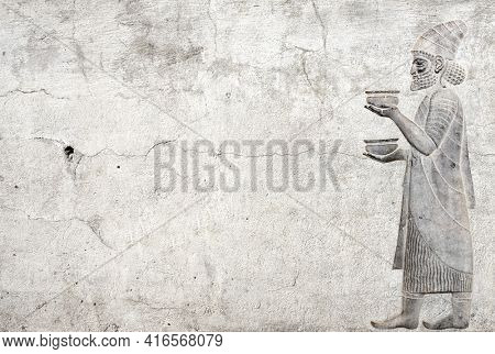 Ancient wall with bas-relief with foreign ambassador with gift and donations, Persepolis, Iran. Horizontal background with embossed image persian bearded man. Mock up template. Copy space for text