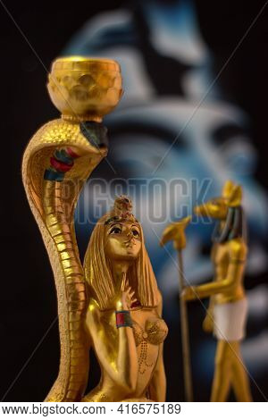 Still Life With Egyptian Figures Of Anubis And Cleopatra With Snake In Gold.