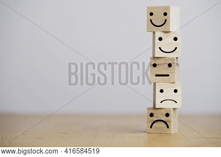 Customer Satisfaction Survey Concept, Human Face Icons Print Screen On Wooden Cube Block On Table Fo