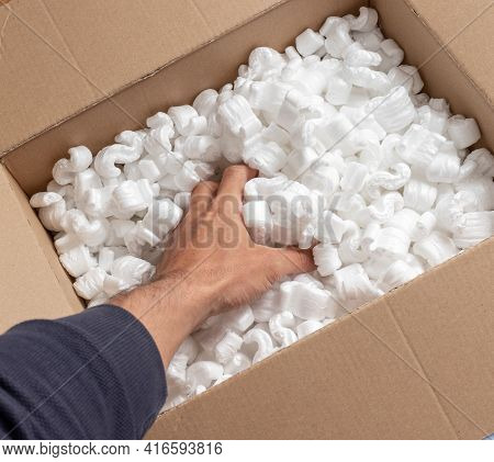 A Cardboard Box With Packing Styro Foam Pellets Top View