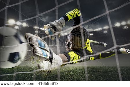 African Male Soccer Or Football Player, Goalkeeper In Action At Stadium. Young Man Catching Ball, Tr