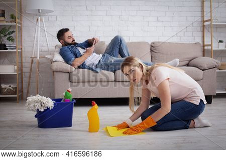 Indifference, Laziness, Household Chores And Chauvinism. Sad Wife Housewife Washed Floors