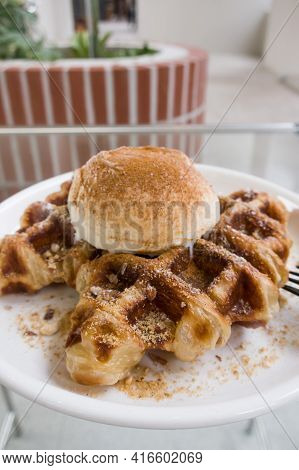 A Baked Croissant Dough In Waffle Iron With A Scoop Of Vanilla Ice Cream.