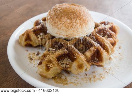 A Baked Croissant Dough In Waffle Iron With A Scoop Of Vanilla Ice Cream.